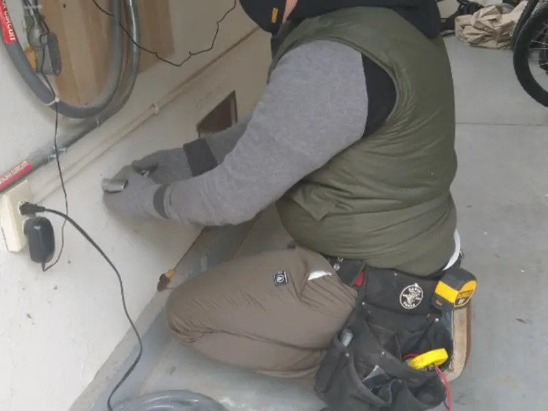 Electrician performing outlet wiring in a Grosse Pointe garage